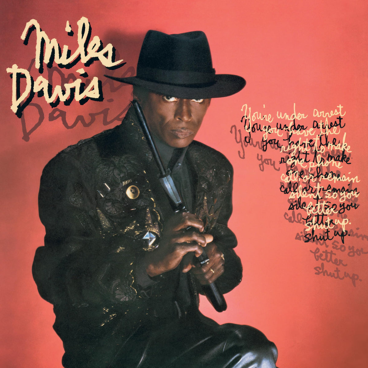 Miles Davis – You're Under Arrest (Red & Clear Marble Colored Vinyl)(LP) by Miles Davis vinyl record cover